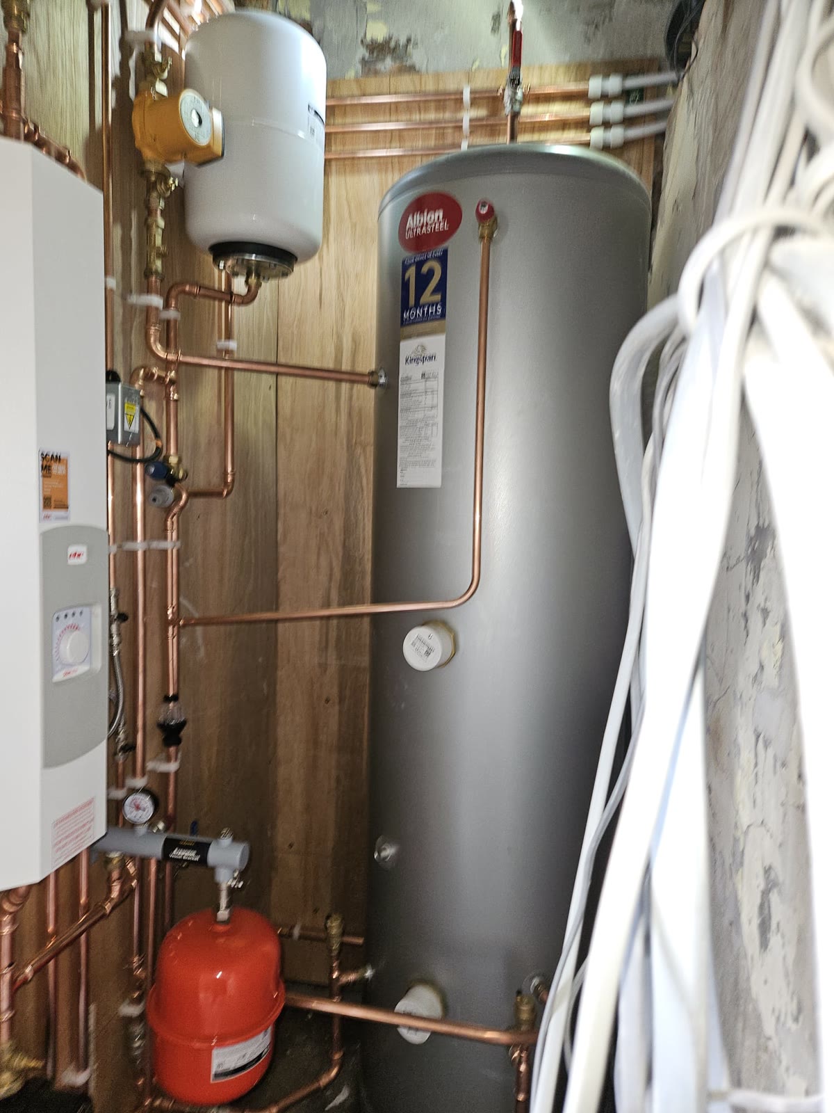 Hot water cylinder with pipework