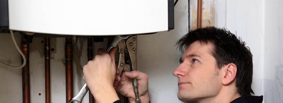 A man repairing a boiler